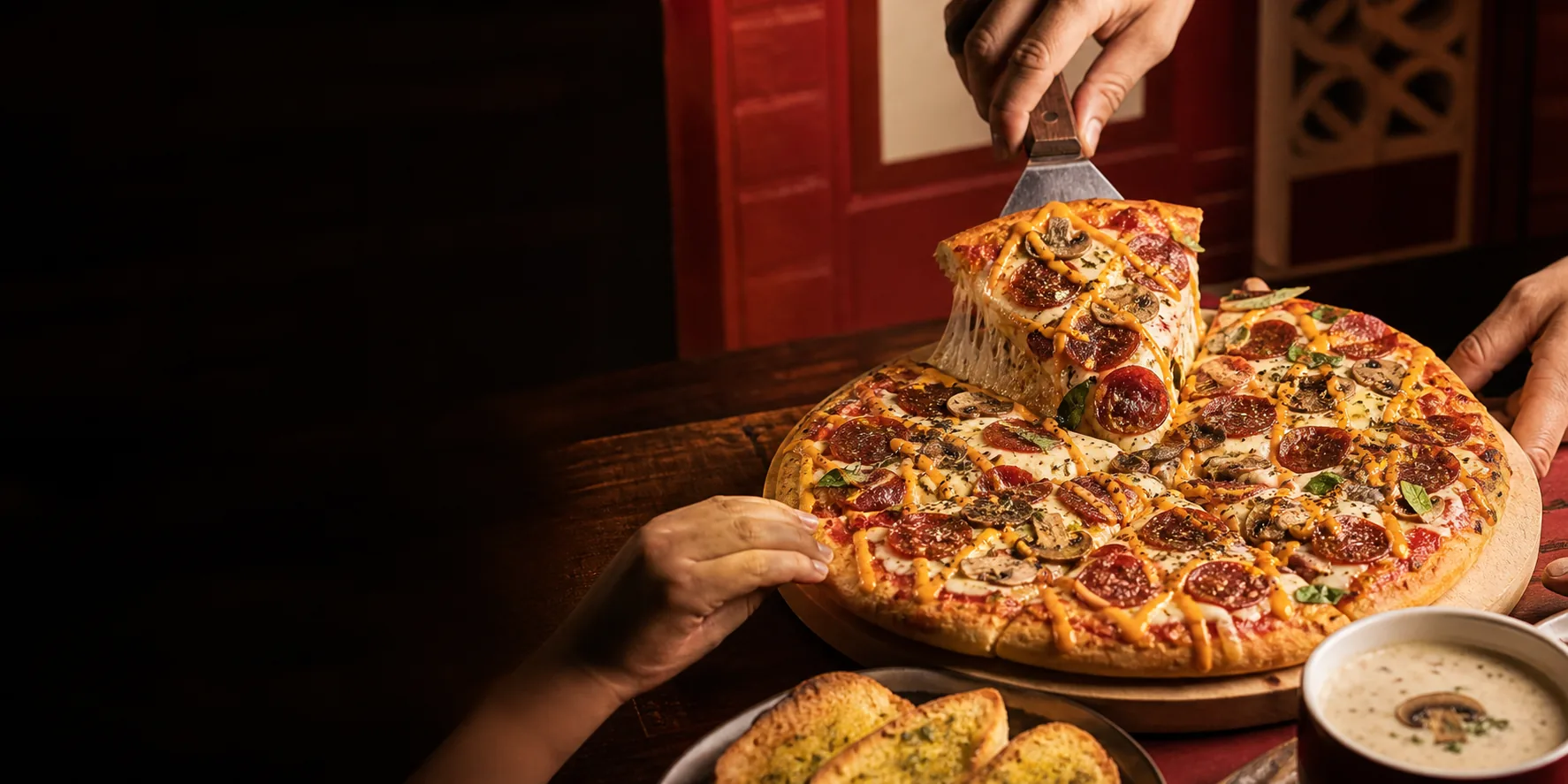 Fresh Mr.Mama-style pepperoni pizza served with garlic bread and mushroom soup